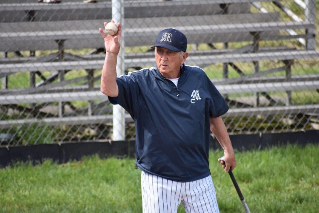 Photo of Coach Dave Cisar talking to his baseball team in 2019. Photo by Teran Malone