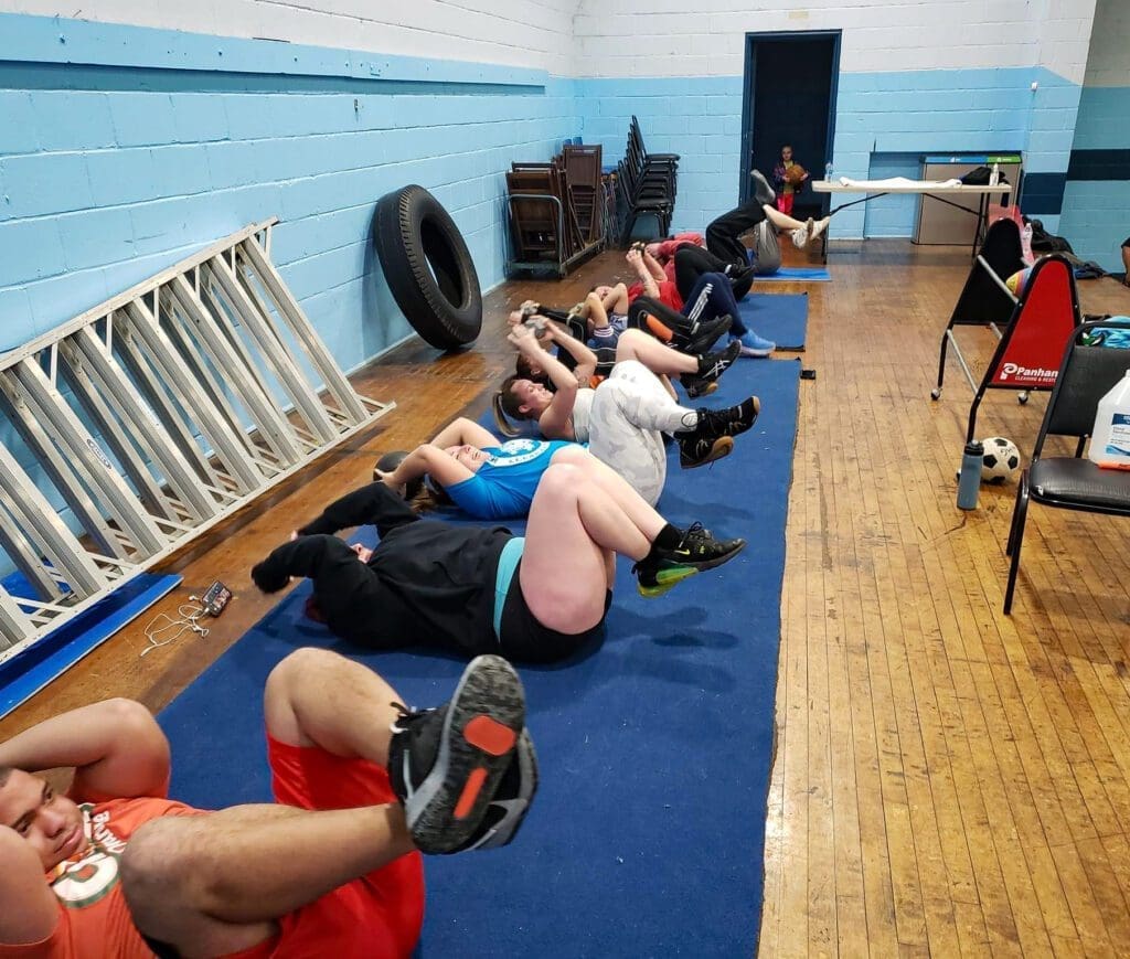 A photo of kids doing sit-ups.