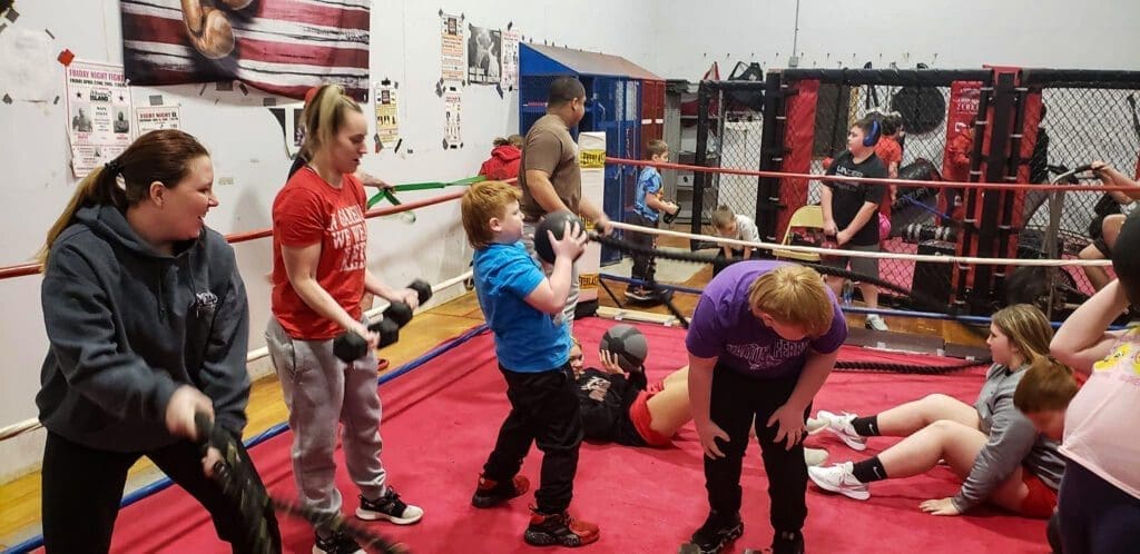 A photo of kids in a boxing ring.