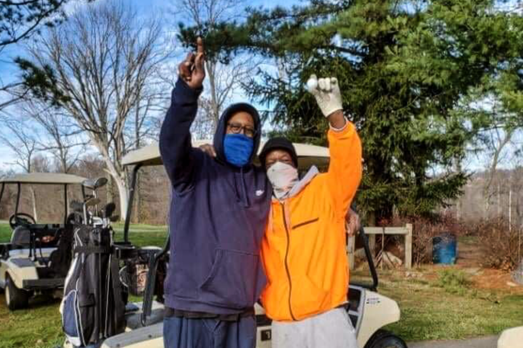 Two men at a golf course.