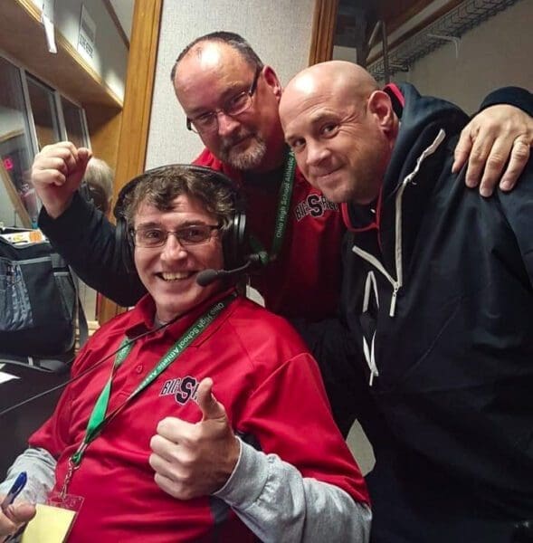 Three guys in a press box.