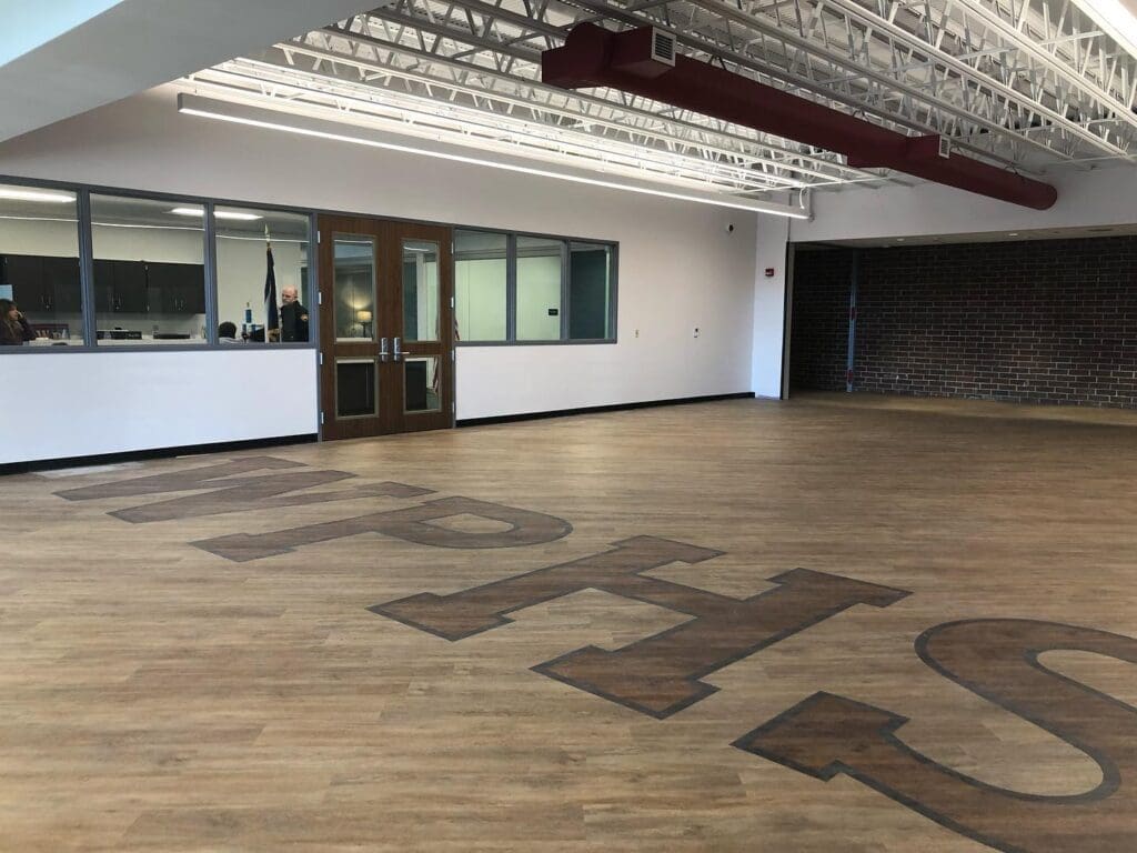 An empty room with initials on the floor.