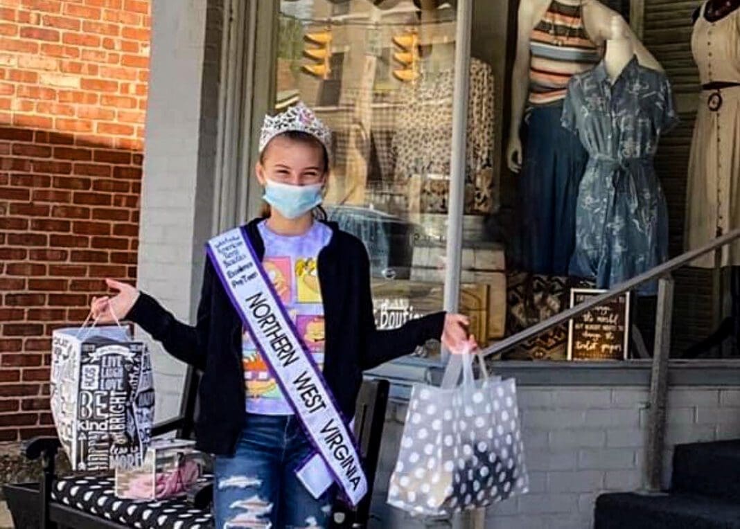 A young lady holding bags.