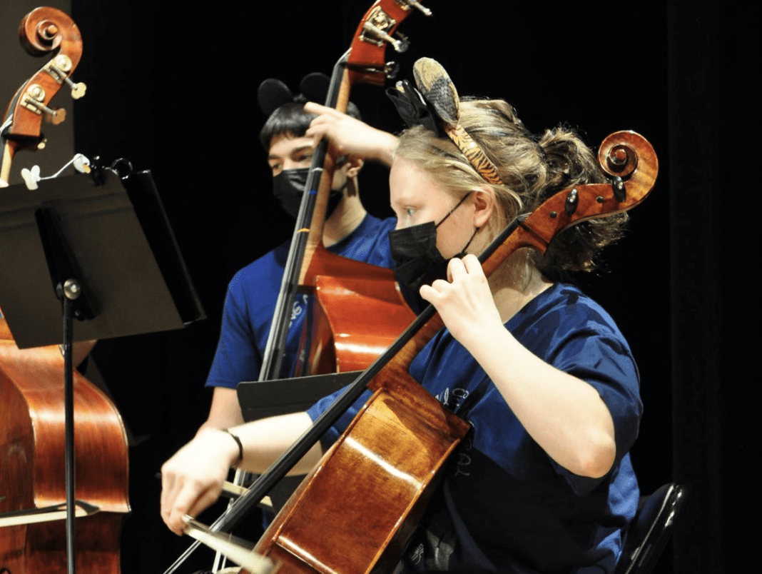 A student playing an instrument.