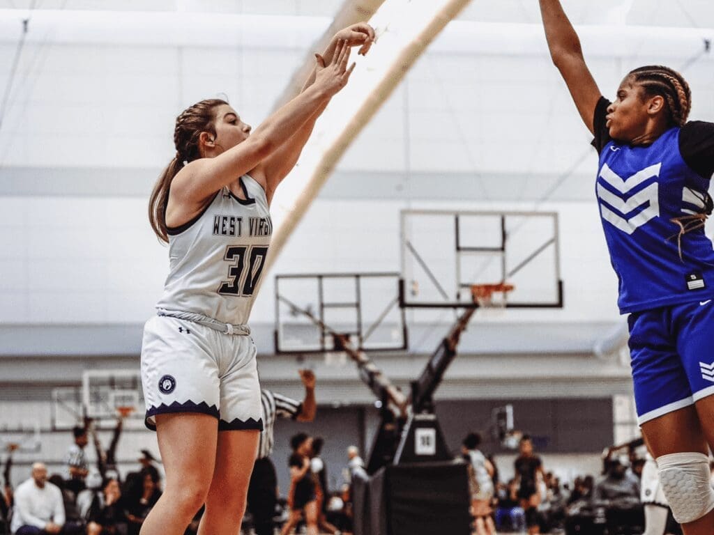 A girl shooting a basketball.