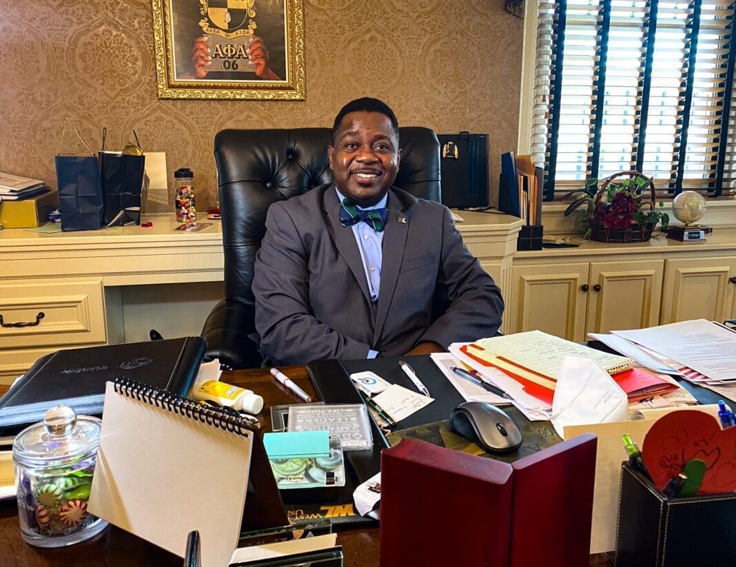 A man sitting at a large desk.