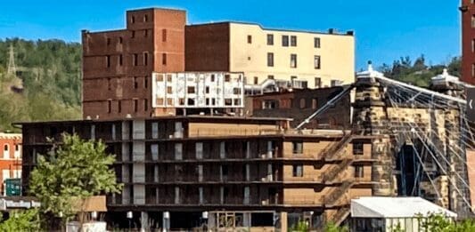 A building witha crumbling sign o the top.