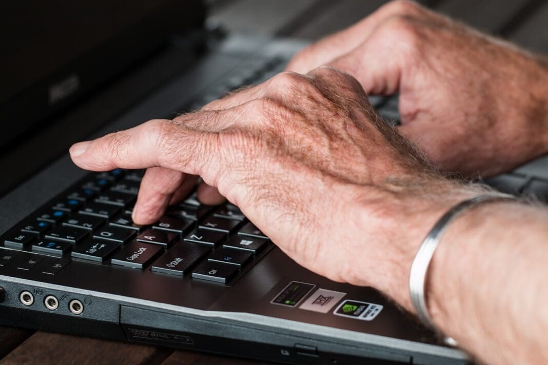 Hands on a laptop.