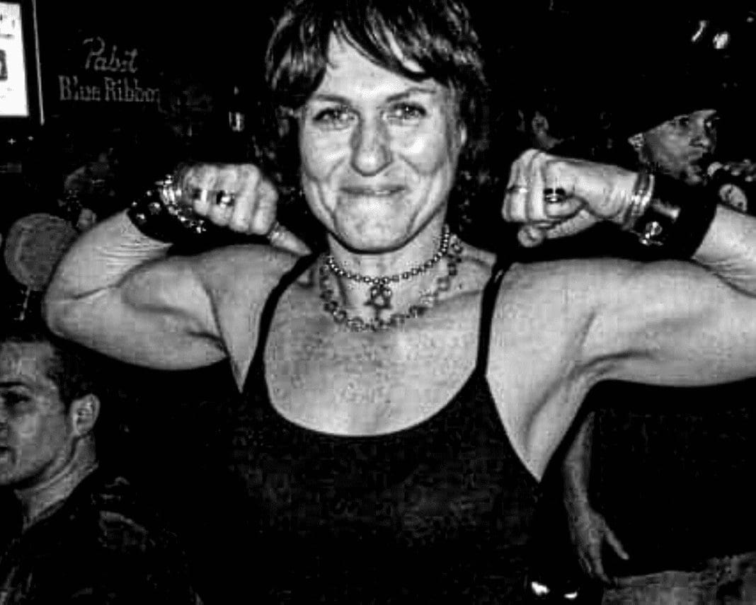 A woman making muscles with her arms.