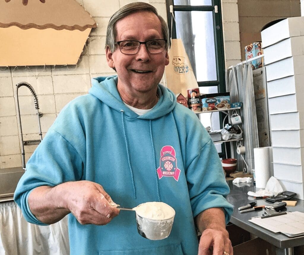 A man with a cup of flour.