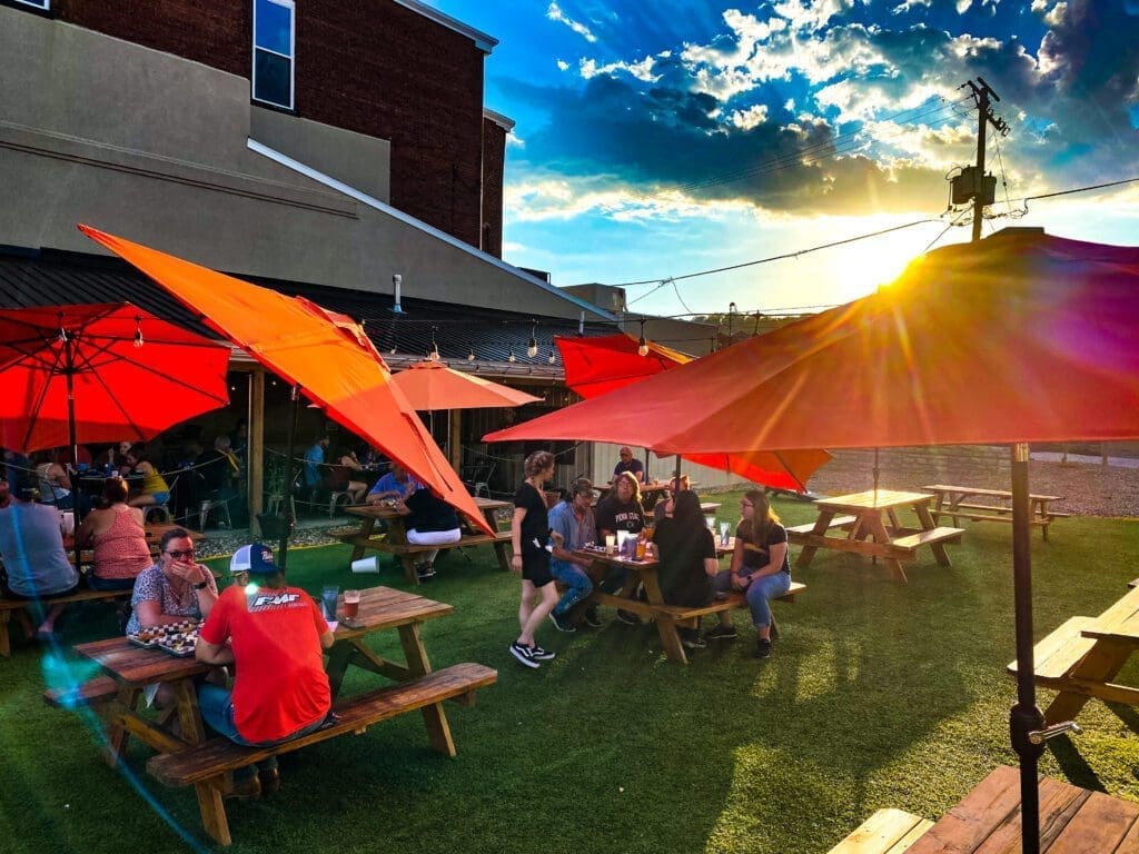 A photo of a yard with picnic tables.