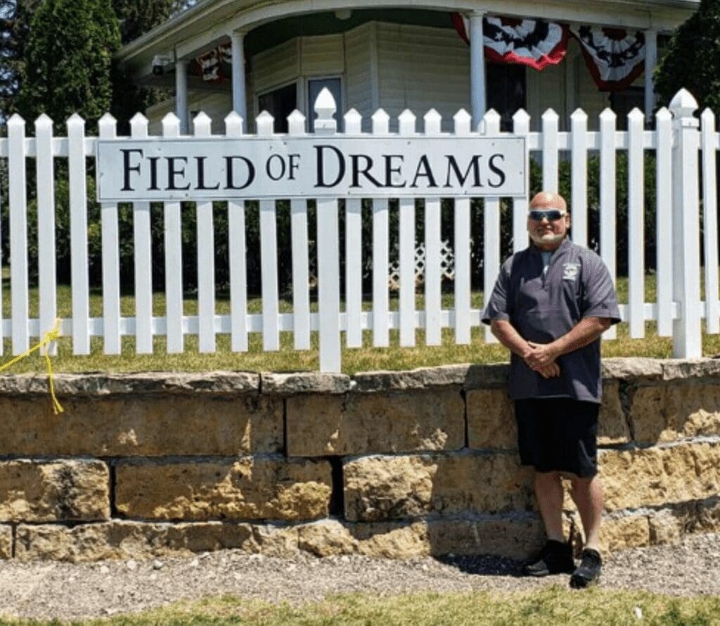 A man in front of a fence.