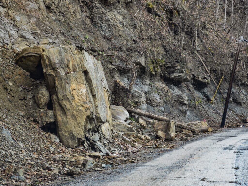 A large rock in a road.