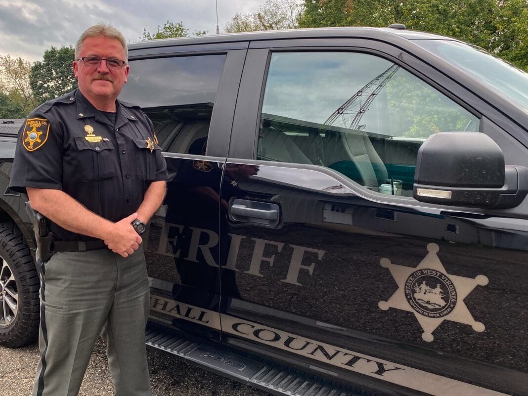 A man next to a cruiser.