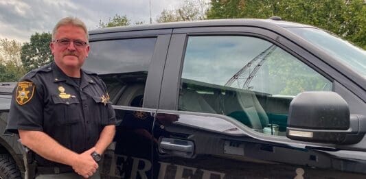 A man next to a cruiser.