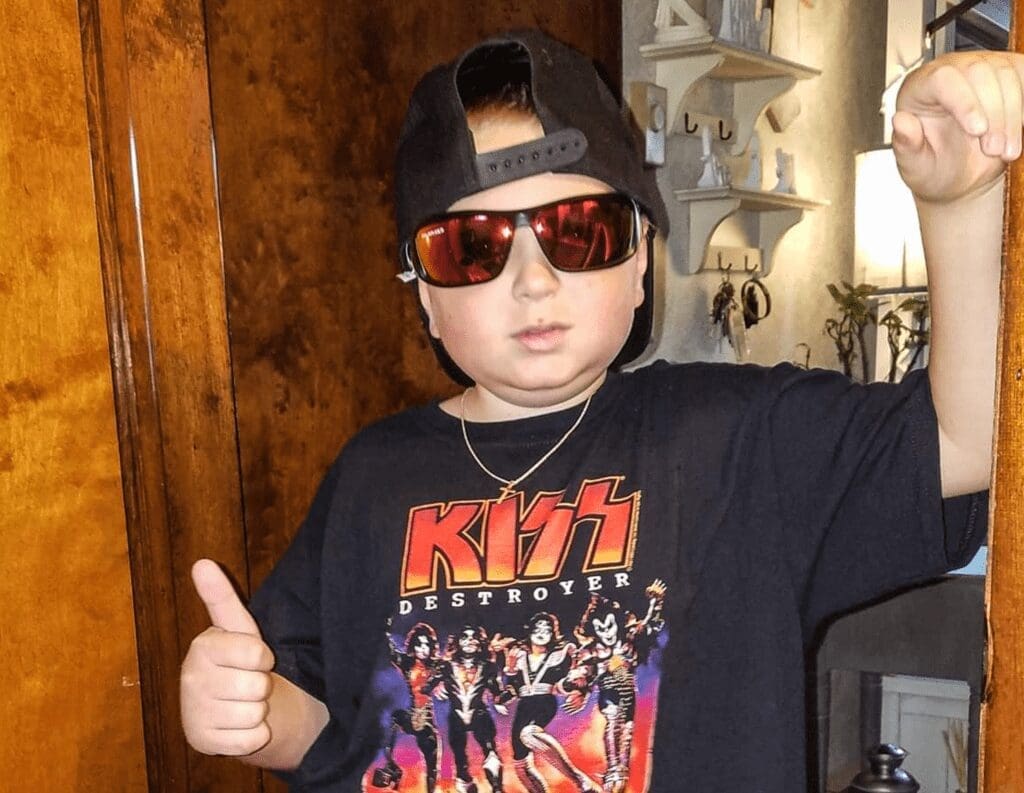 A boy with his thumb up.