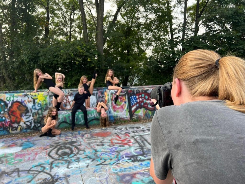 A woman taking photos of dancers.