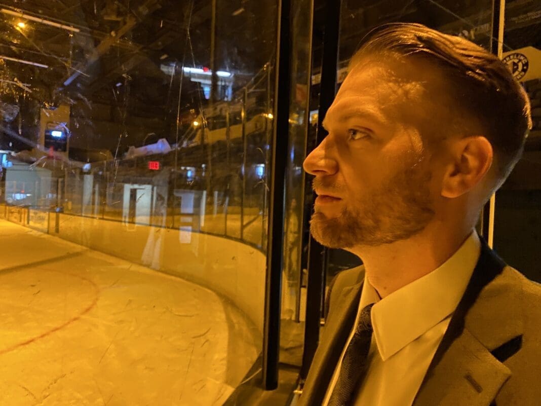 A man looking at a rink.