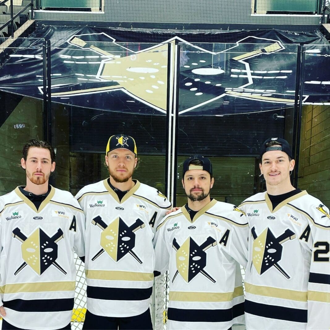 Four players posing for a photo.