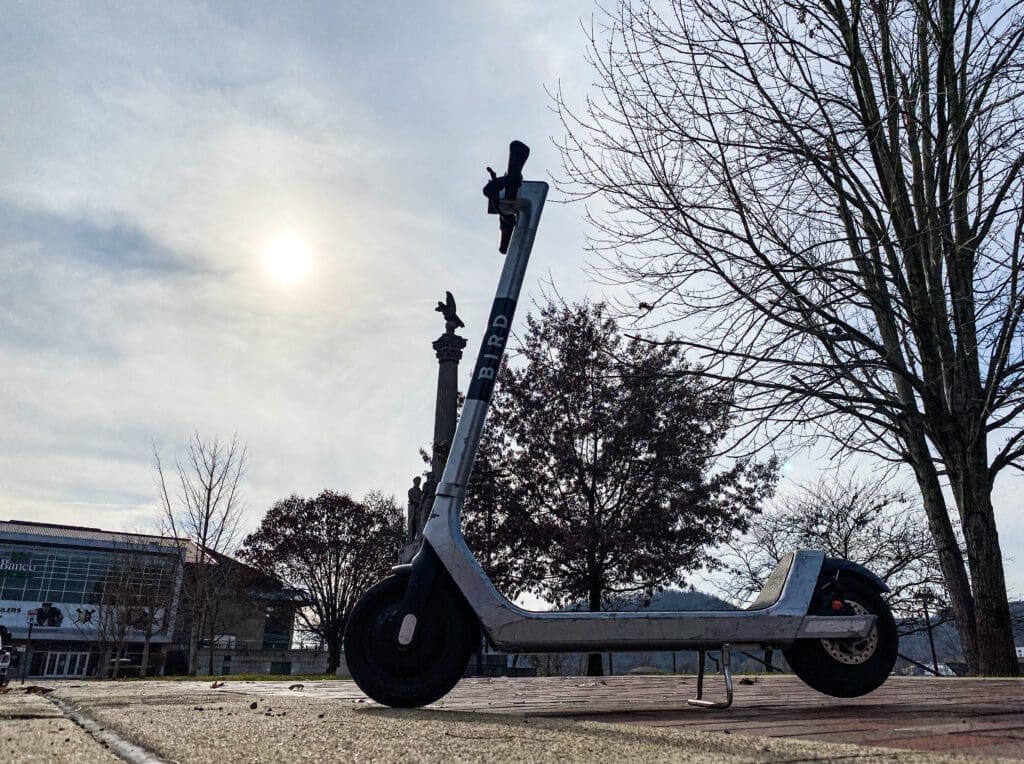 A scooter on a sidewalk.