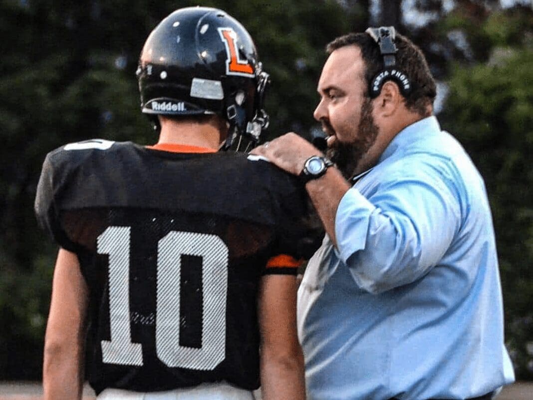 A coach speaking with his player.