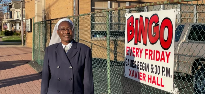 A lady near a fence.