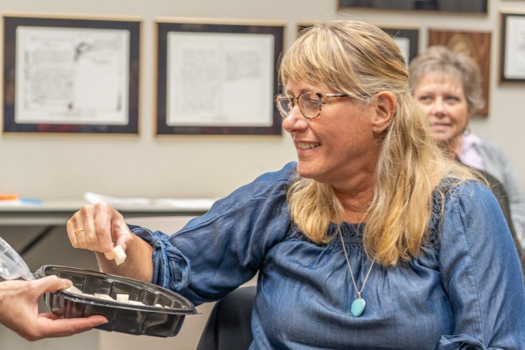 A woman eating cheese.