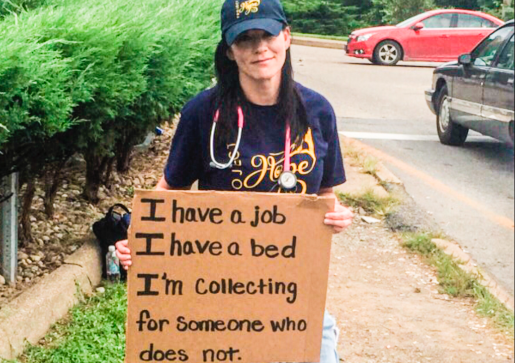 A female holding a sign.