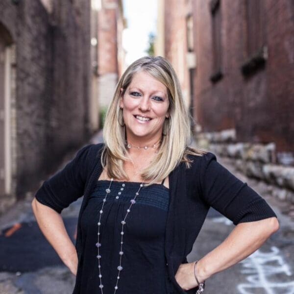 A photo of a woman in an alley.