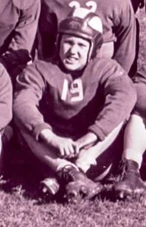 A boy in a football uniform.