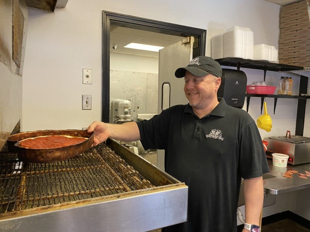 A man making pizza.