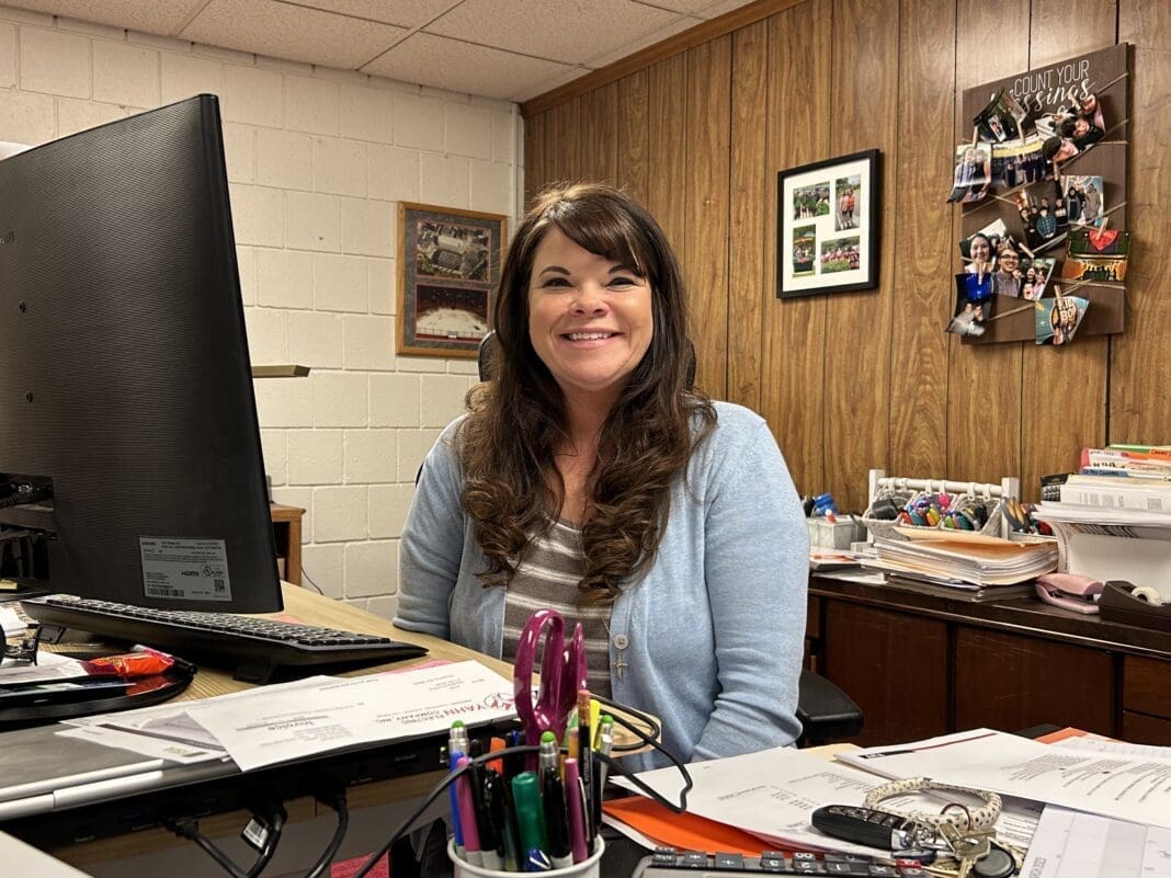 A lady at her desk.