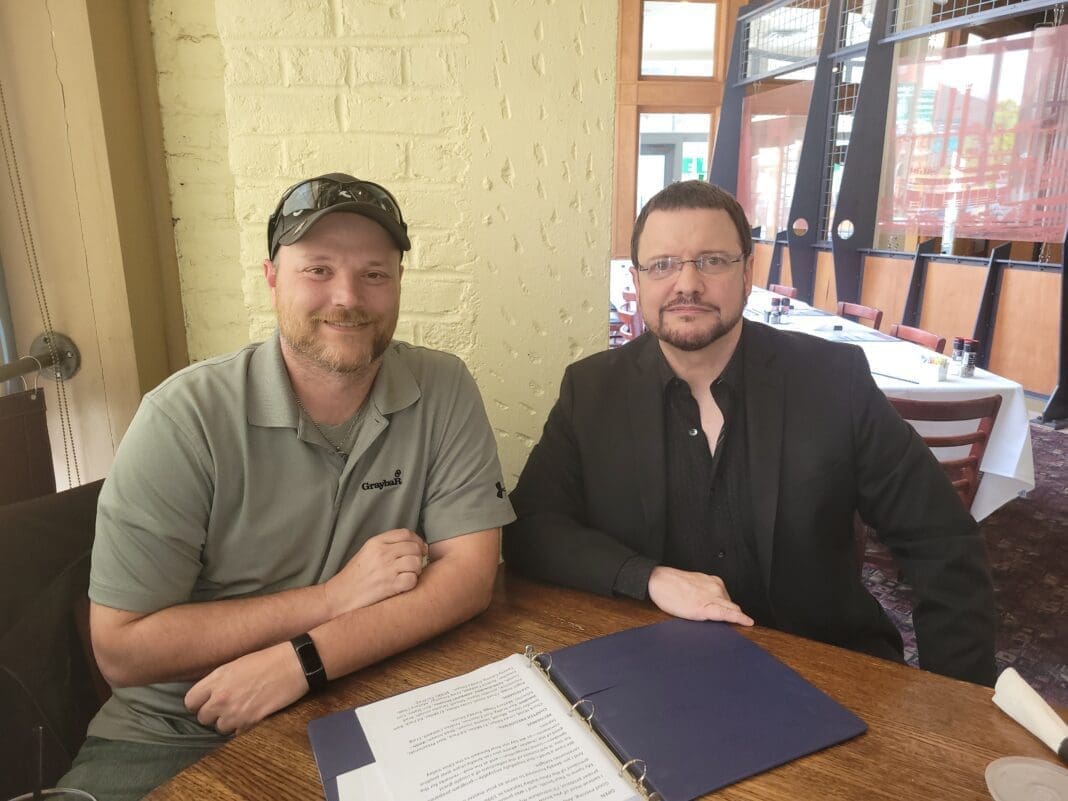 Two men at a table.