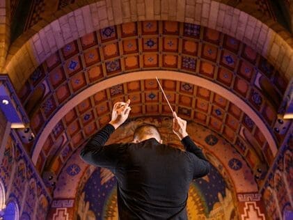 A man conducting.