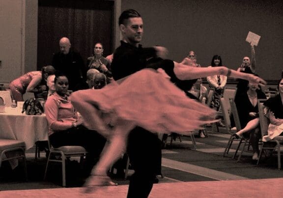 A photo of two people dancing.