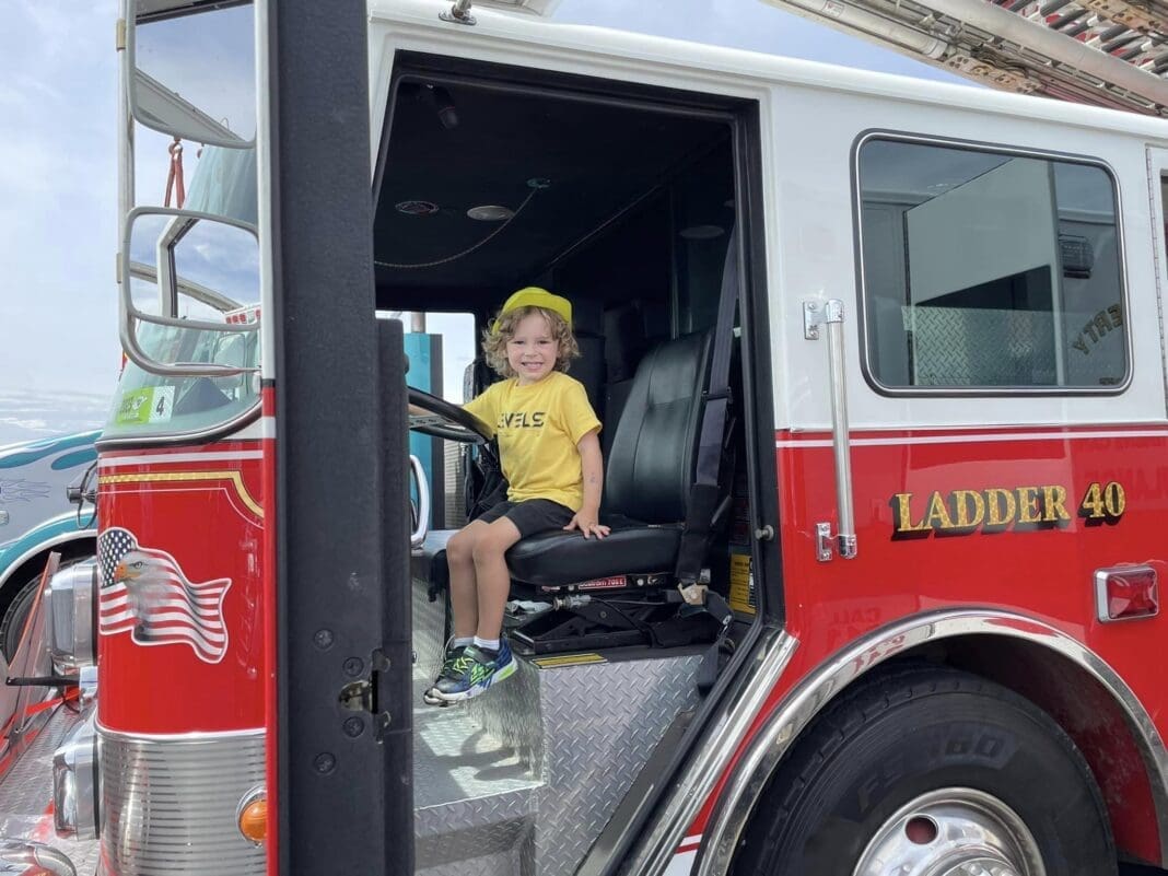 A kid in a fire truck.