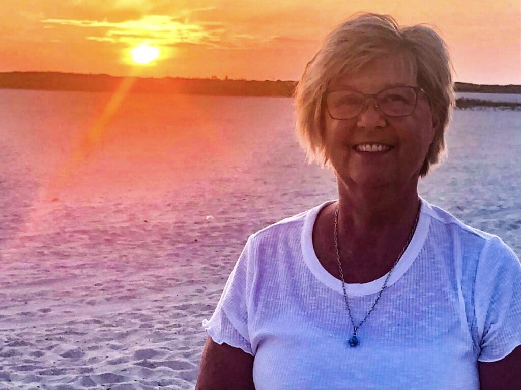 A woman standing on the beach.