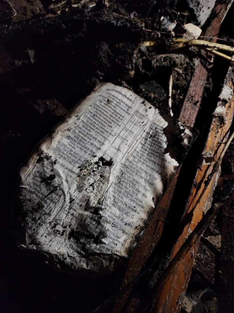 A charred Bible page.