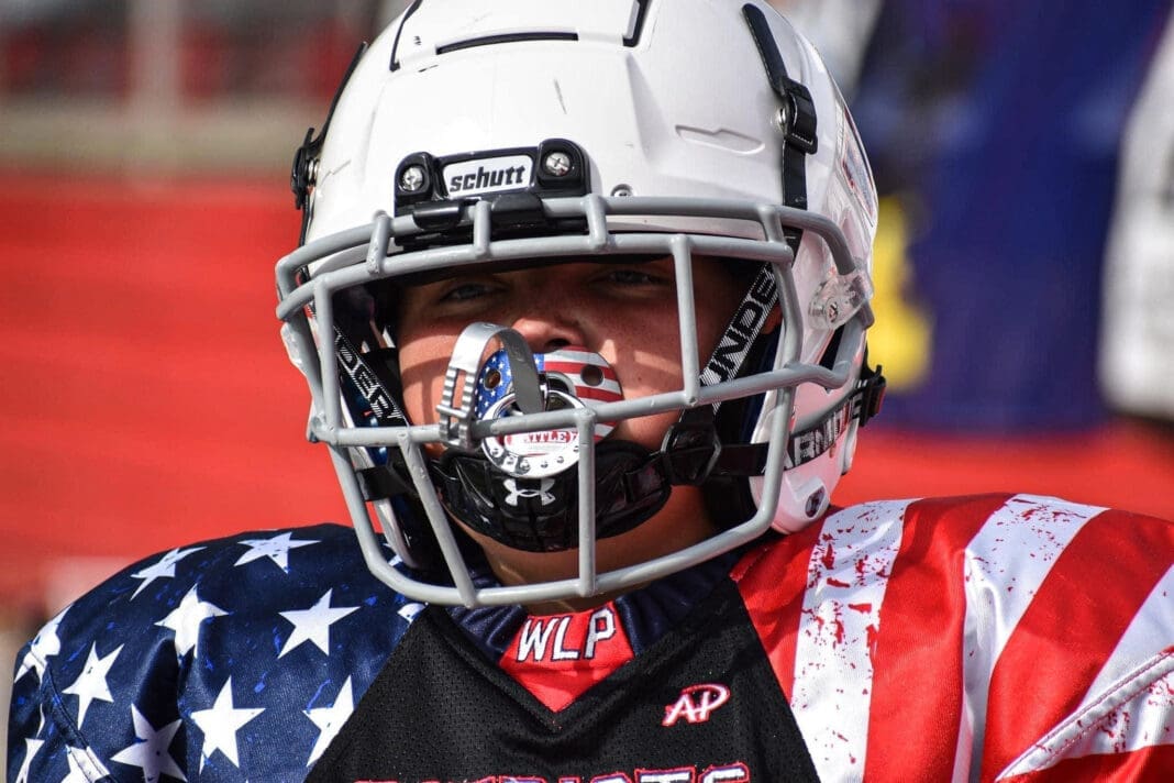 A kid in a football helmet,