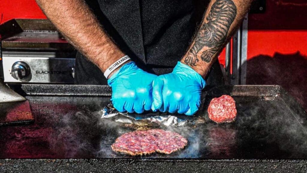 A burger on a grill.