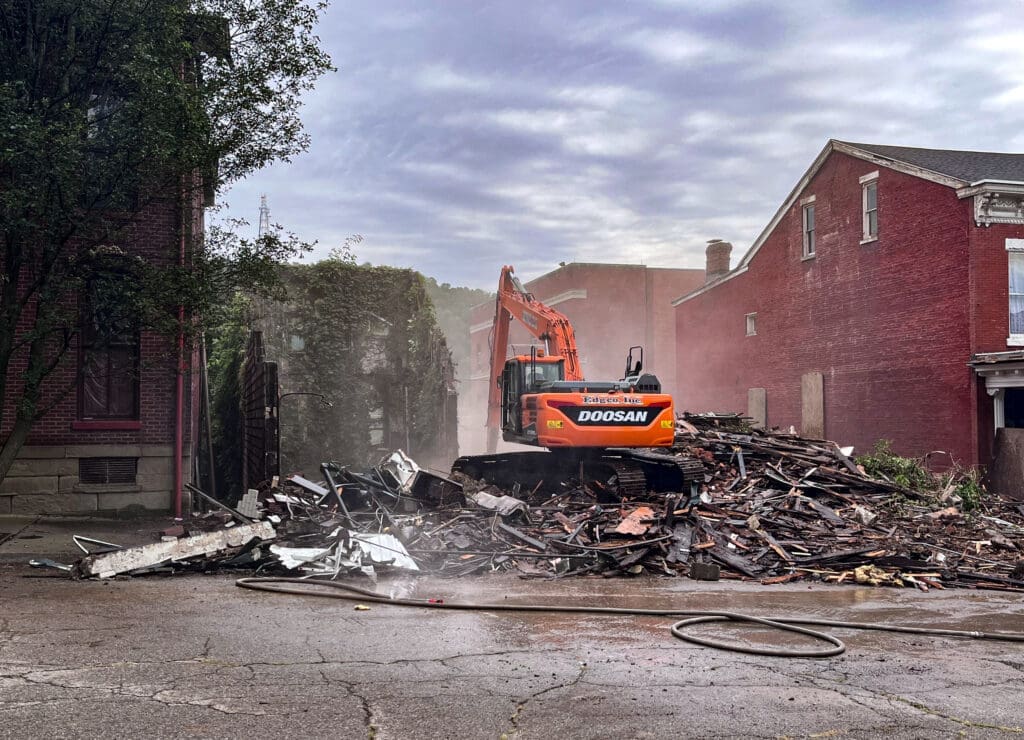 A backhoe on rubble.