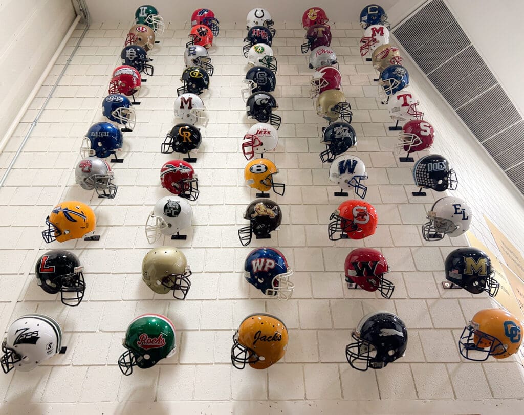 A wall of football helmets.