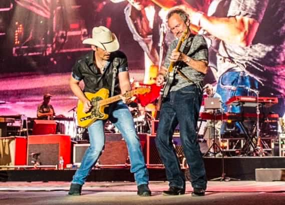 Two men playing guitars.