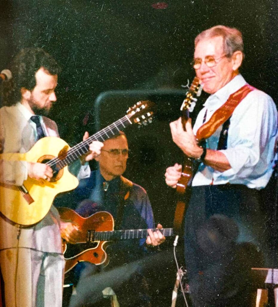 Two men playing the guitar.