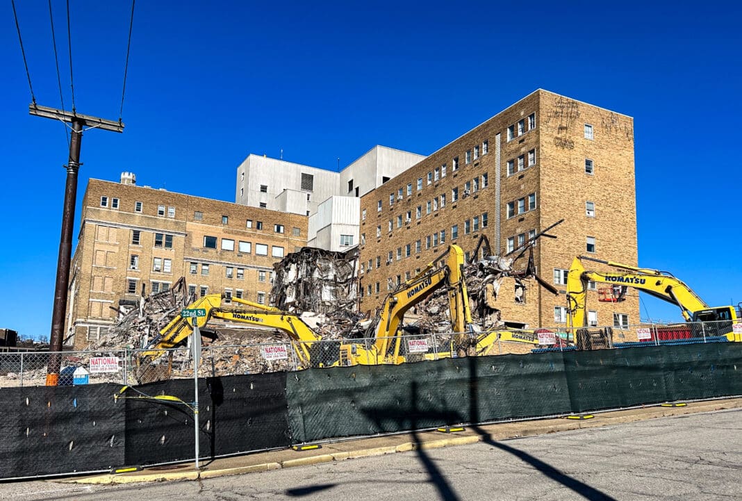 Excavators taking down a building.