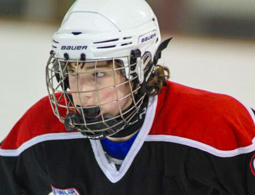 A kid playing hockey.