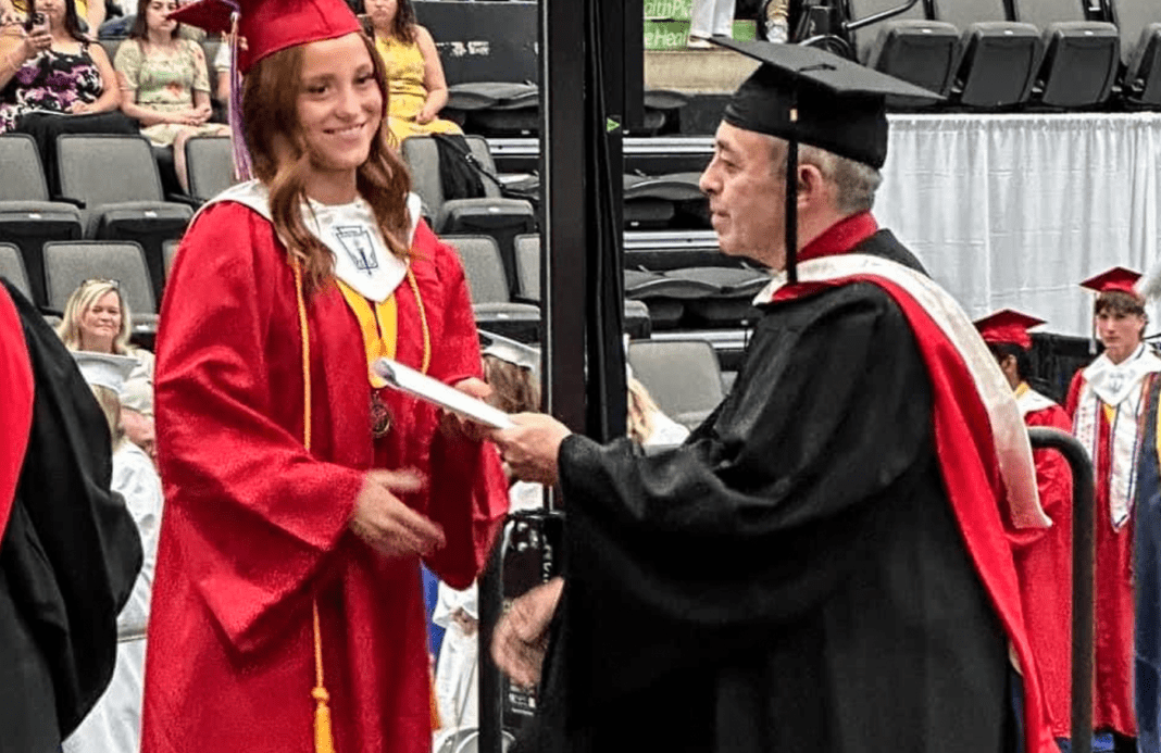 A man in a grad gown.