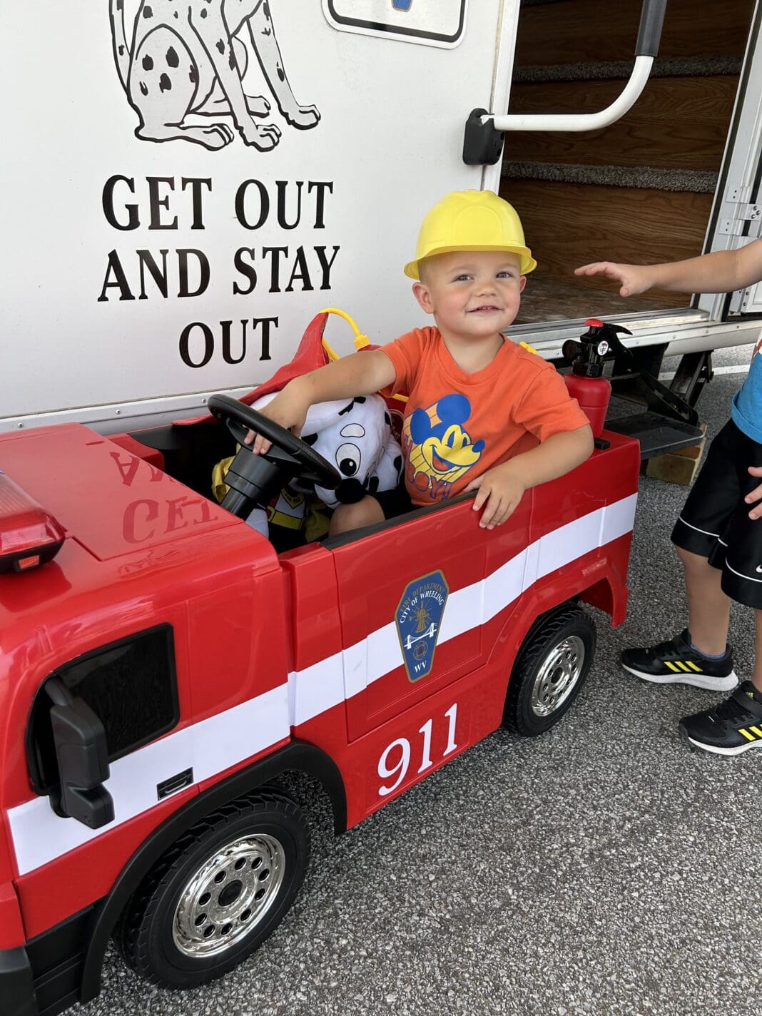 A child in a toy truck.