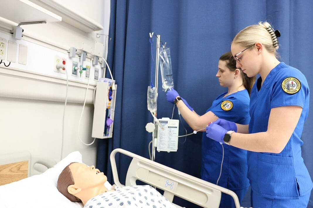 Students in a fake hospital.