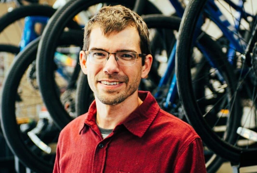 A man in front of bikes.